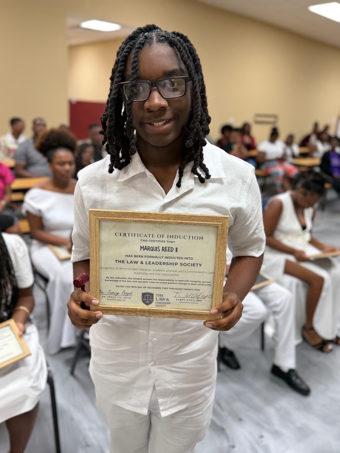 An LLS student celebrating induction into the Law and Leadership Society