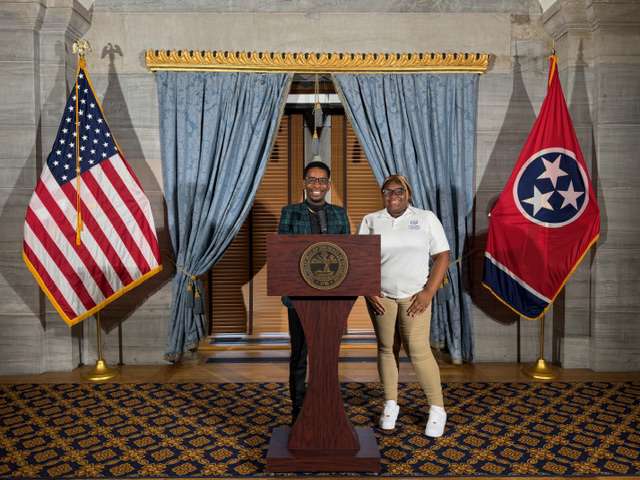 LLS students speaking at a podium during a civic visit